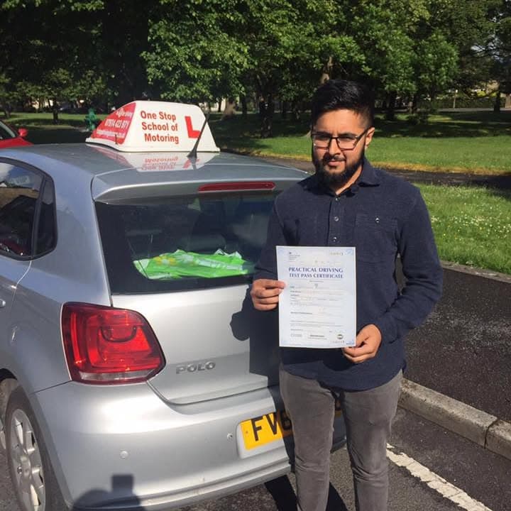 Newly passed learner holding their practical test pass certificate beside the One Stop School of Motoring car